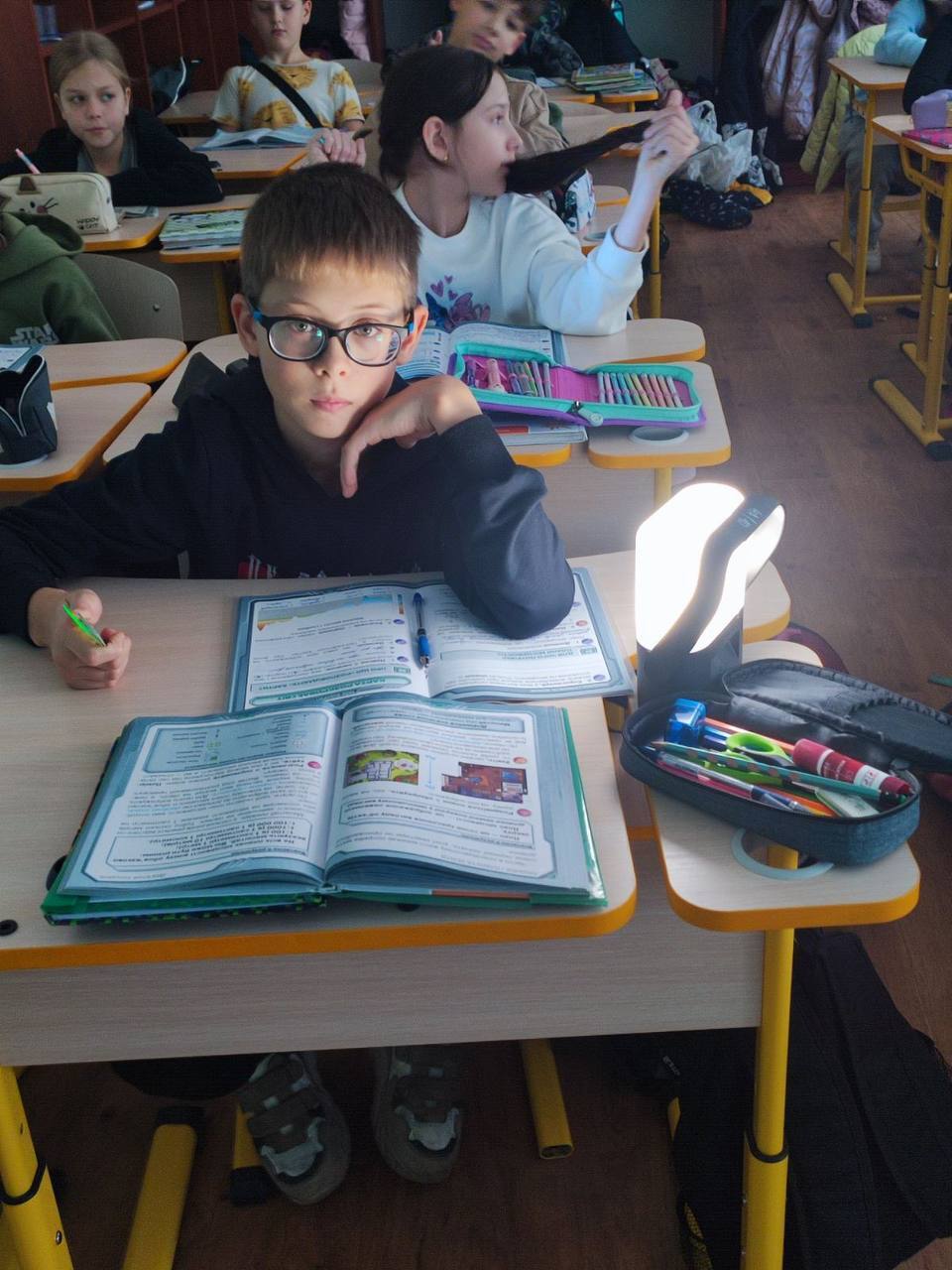 A student uses the Sol Mid Capacity to read. Teachers reported meaningful improvements in classroom functionality during alert periods, noting that students were able to read, draw, and write without straining their eyes.