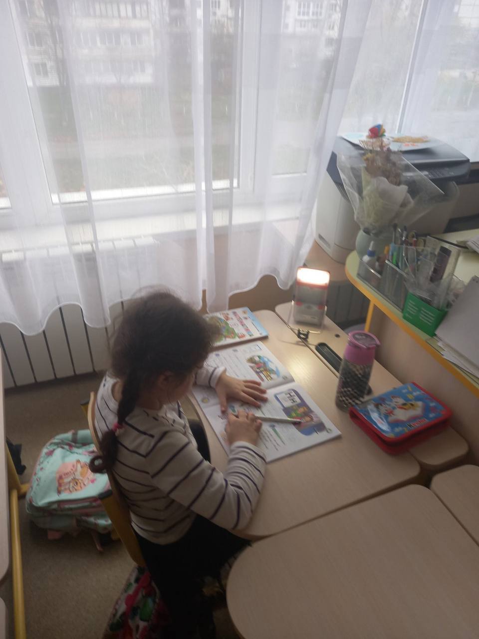 A student uses the Move solar lamp to read in class