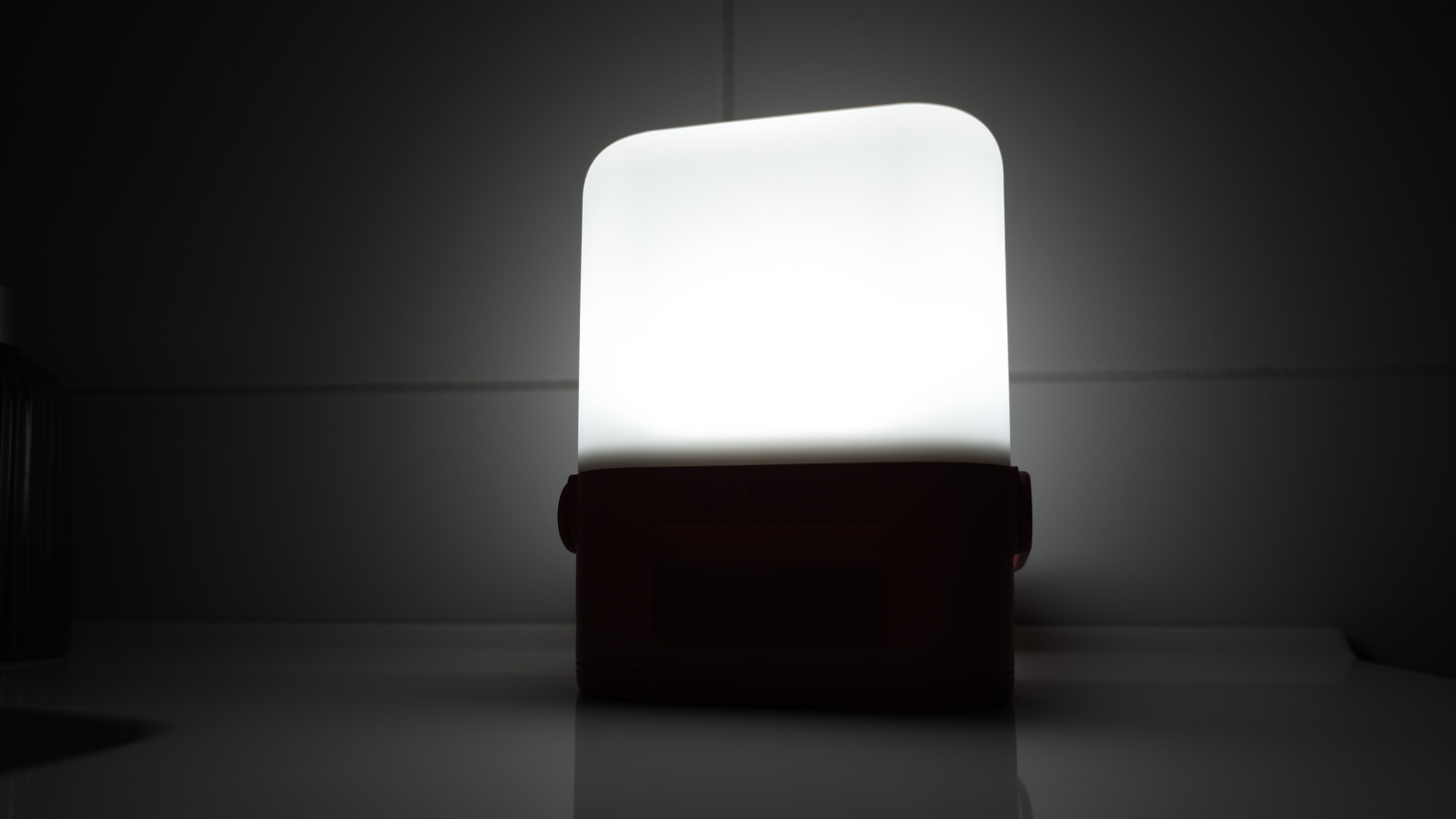 BRIGHT solar lamp for emergencies glowing in a dark indoor space, ideal for emergency kits during power outages or severe weather.